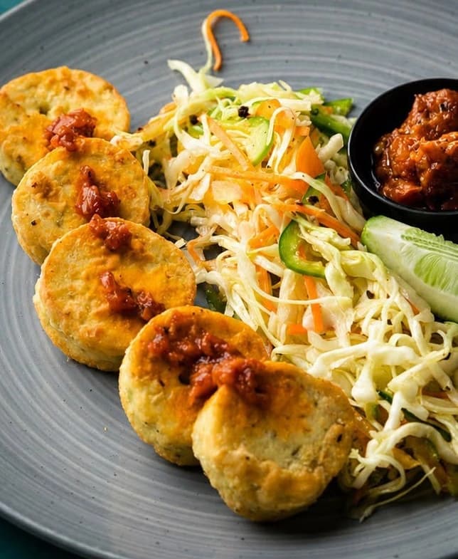Fish Cake: round fried fish cakes with a spicy relish, cabbage salad and cucumber