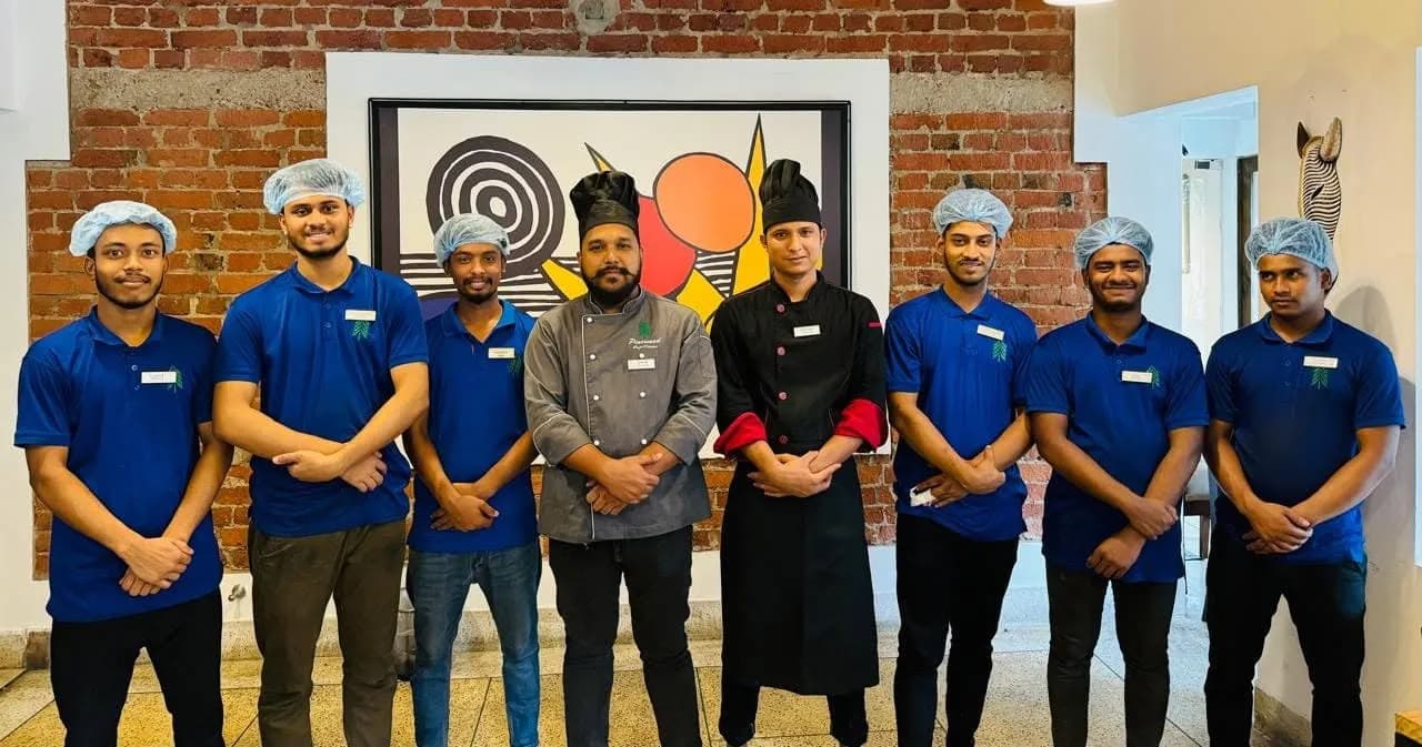 The Pinewood chefs and floor staff standing in front of a brick wall